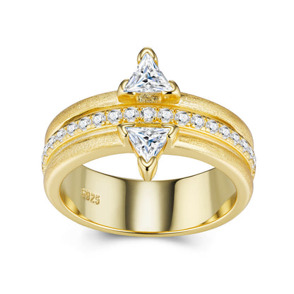 Gold ring with triangular gemstones on a white background