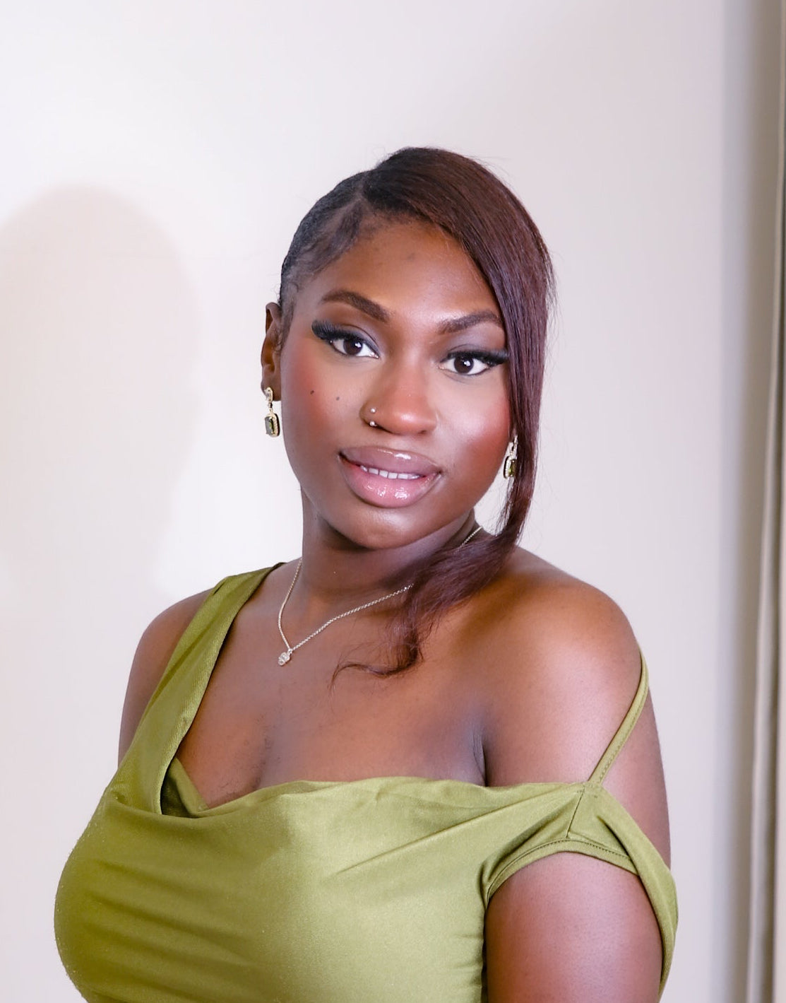 Woman wearing a green dress against a white background