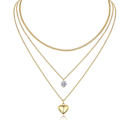 Three gold necklaces with heart and round pendants on a white background